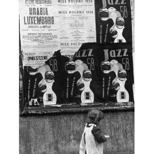  Child Walking Past Posters Advertising Jazz Festival 