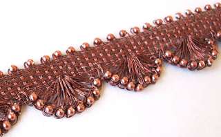 An elegant, hand made trim. Fashioned from metallic, lurex covered 