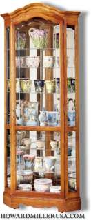 Howard Miller Oak Corner curio Cabinet with mirror back  680250 