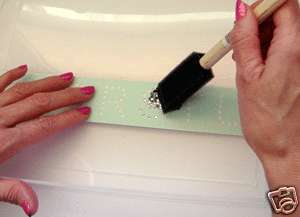 Brush in your stones until all holes are filled. Use tweezers to 